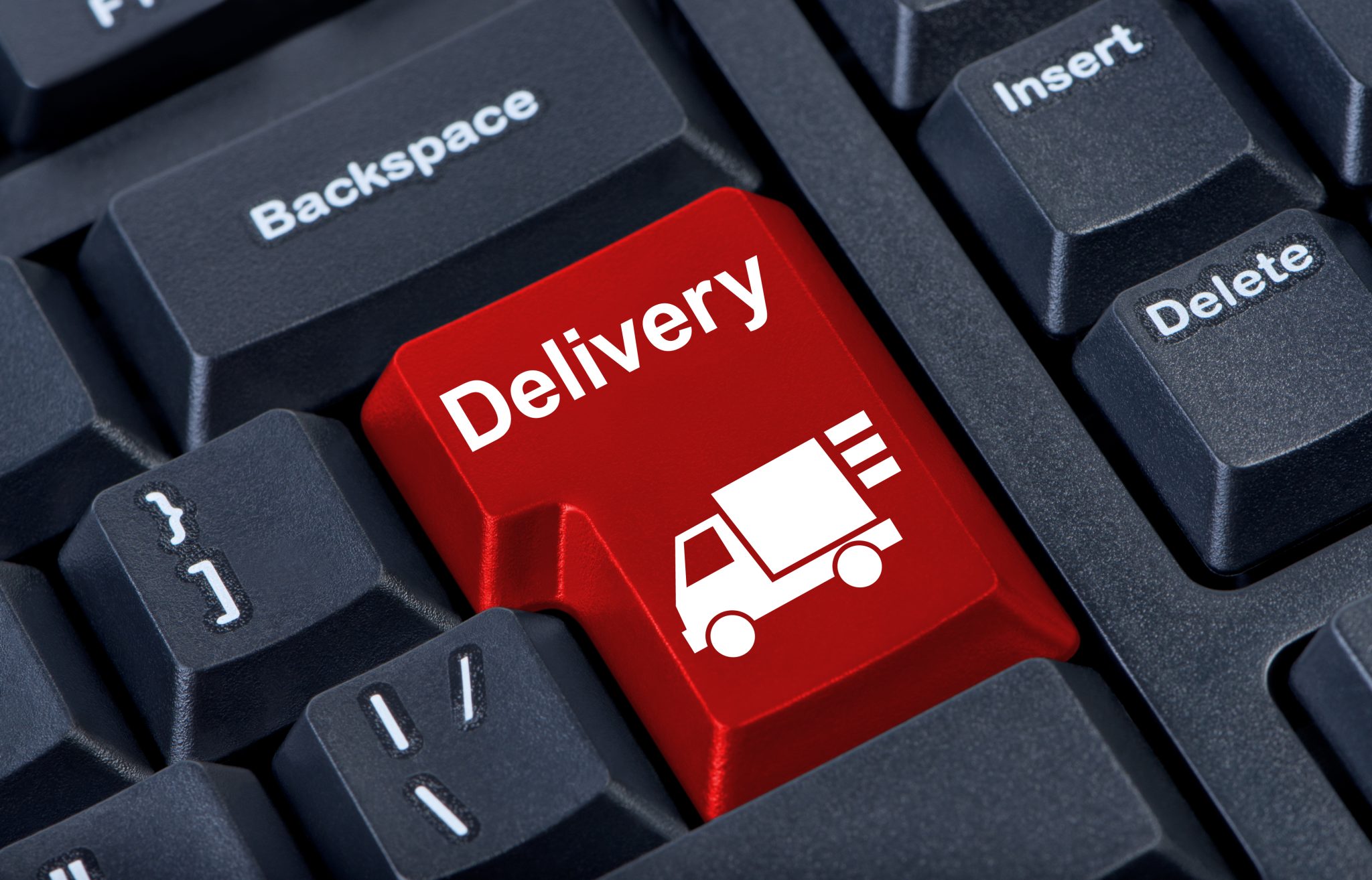 Bright red button on a computer keyboard that says “delivery”