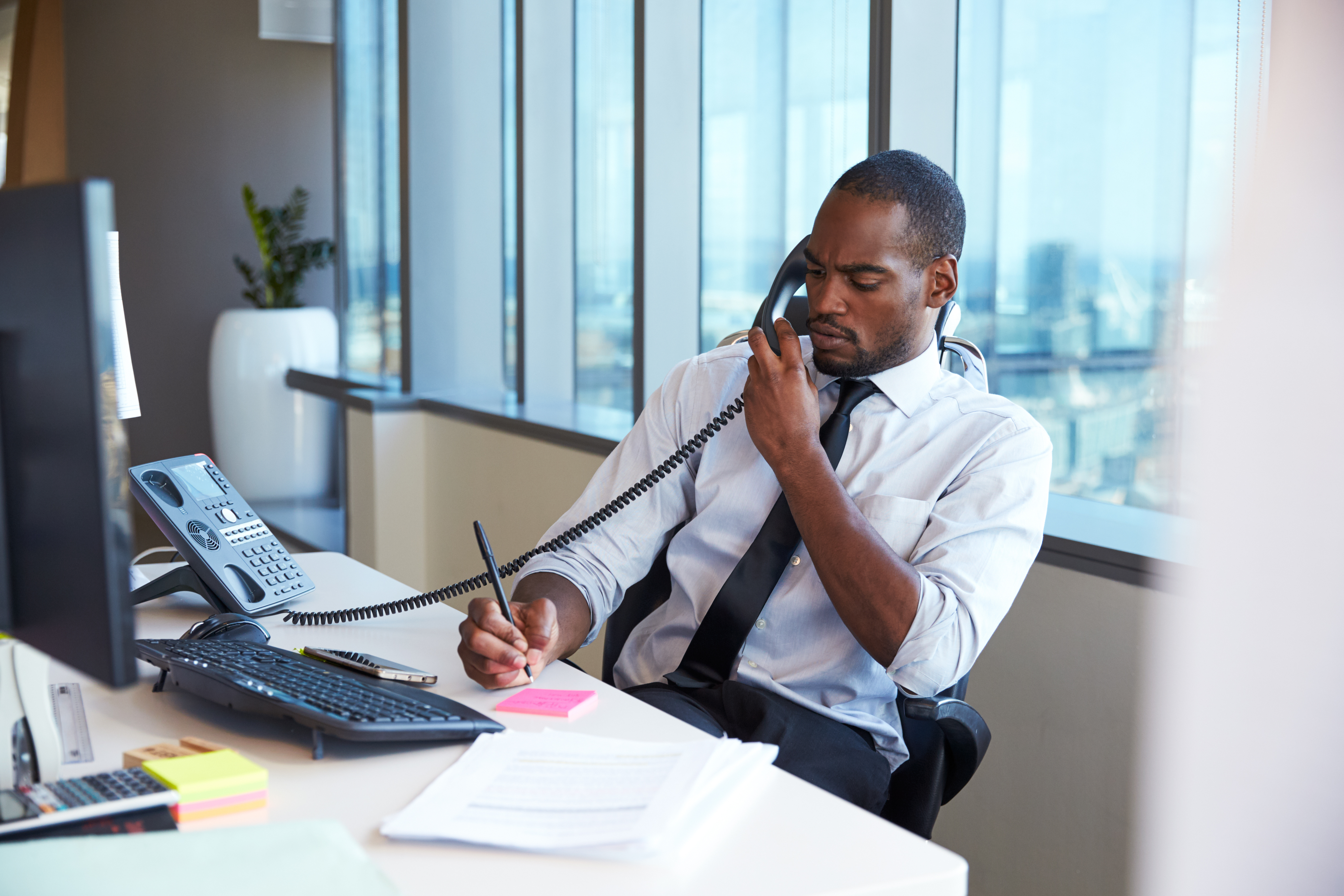 Businessman making a phone call at his desk